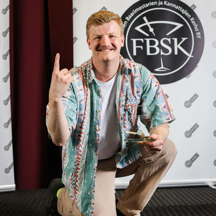 Nico flairtending-kilpailussa FBSK:n taustakankaan edessä